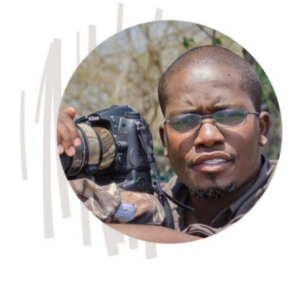 A close-up image of a safari guide with a digital SLR camera.